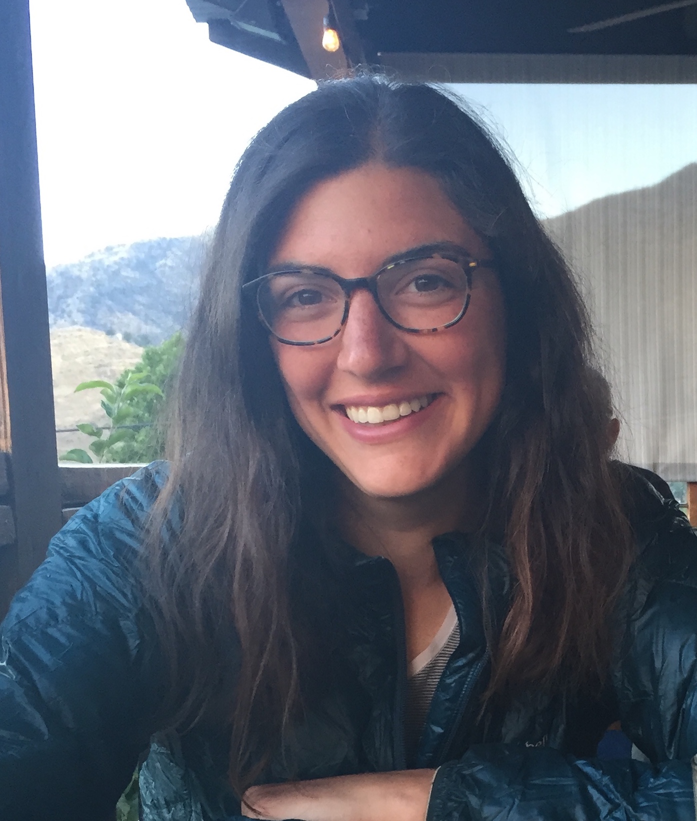 Girl with long hair and glasses by window