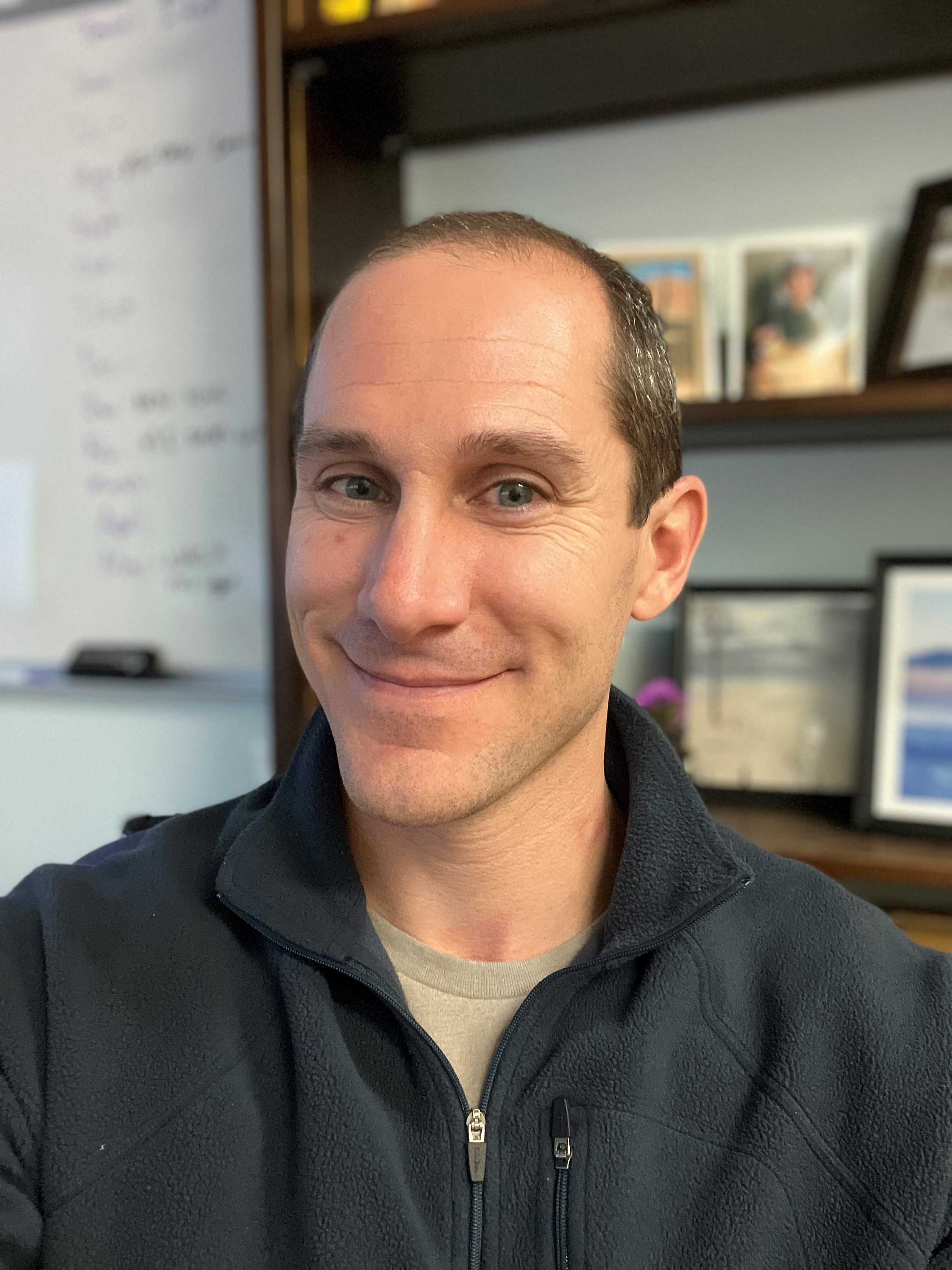 Man in front of bookcase