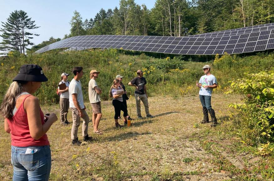 Students standing near a solar array