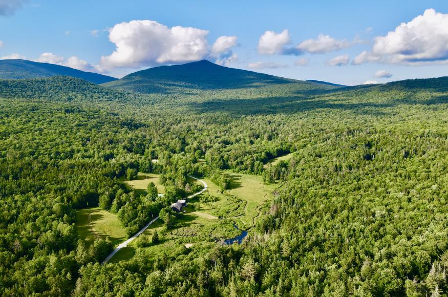 Drone image of Jockey Hill Farm nestled at the base of Shrewsbury Mountain in Shrewsbury, Vermont