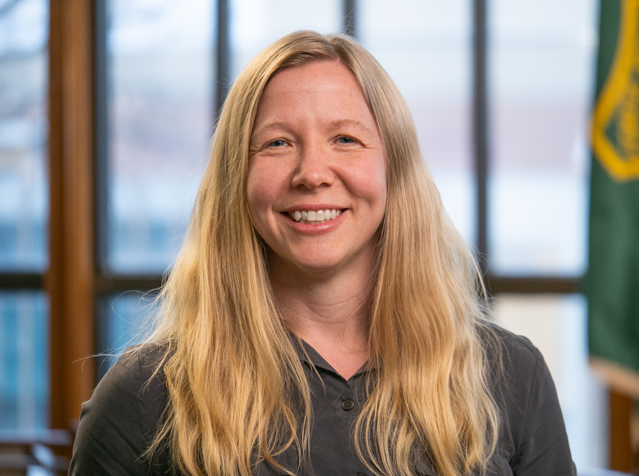 Women in front of windows and flag